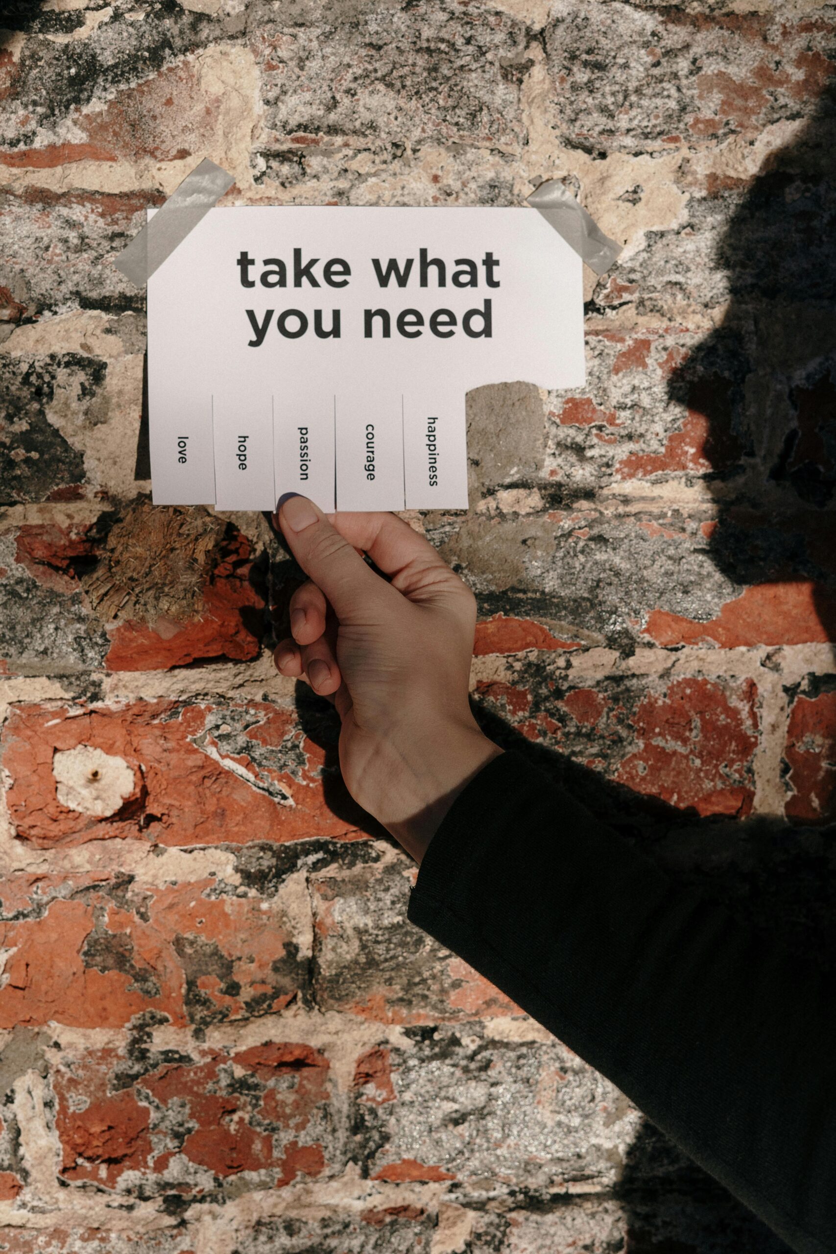 take what you need sign with hand